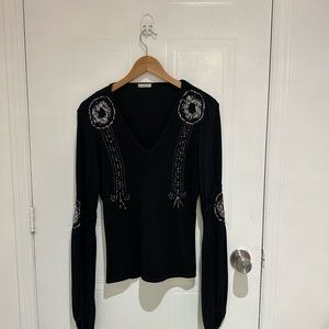 Cacharel shirt with accessories on it